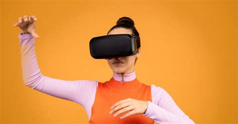 Woman in Orange and Pink Sweat Shirt Wearing Vr Goggles · Free Stock Photo