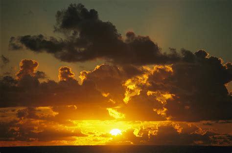 Sunset Through Dramatic Clouds Photograph by Todd Gipstein