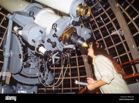 Hispanic woman astronomer research telescope view look study sky star Griffith Observatory Los ...