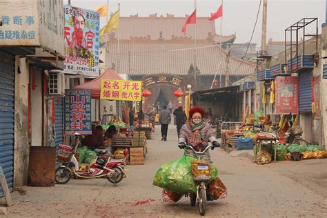 The Real China, Anyang City | A woman makes her way from a t… | Flickr