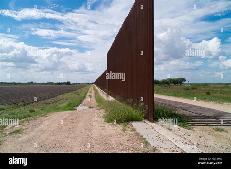 Texas border fence sits atop a dike near the Texas/Mexico border. This ...