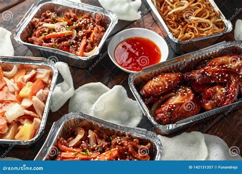 Chinese Takeaway Food. Crispy Shredded Beef, Sweet and Sour Chicken Wings, Egg Noodles with Bean ...