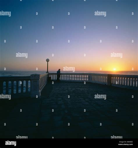 Beach promenade at sunset Stock Photo - Alamy