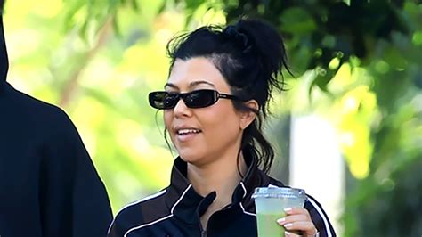 Kourtney Kardashian's baby bump spills over her unbuttoned jeans on ...