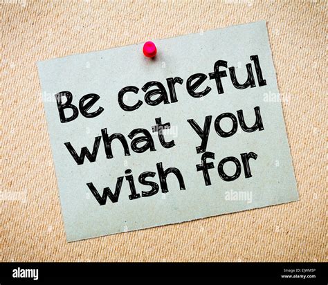 Be careful what you wish for Message. Recycled paper note pinned on cork board. Concept Image ...