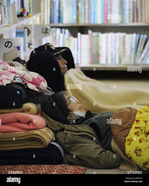 ISHINOMAKI, Japan - Tsunami survivors rest in a library serving as an ...