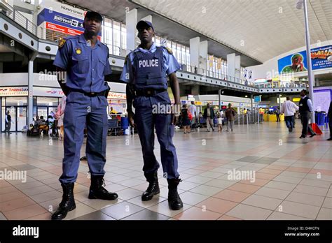 Policemen pictured in the terminal of a bus station in Johannesburg ...