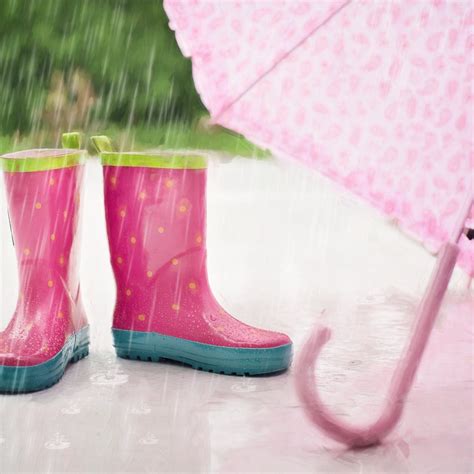 red and gray rain boots near pink umbrella