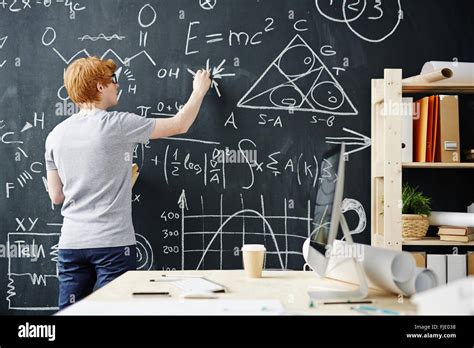 College student writing on the chalkboard during a math class Stock Photo - Alamy