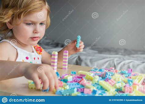 Small Preschooler Girl Playing with Colorful Toy Building Blocks, Sitting at the Table Stock ...