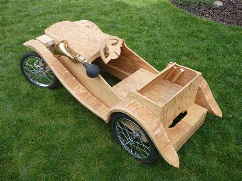 a wooden toy car sitting in the grass