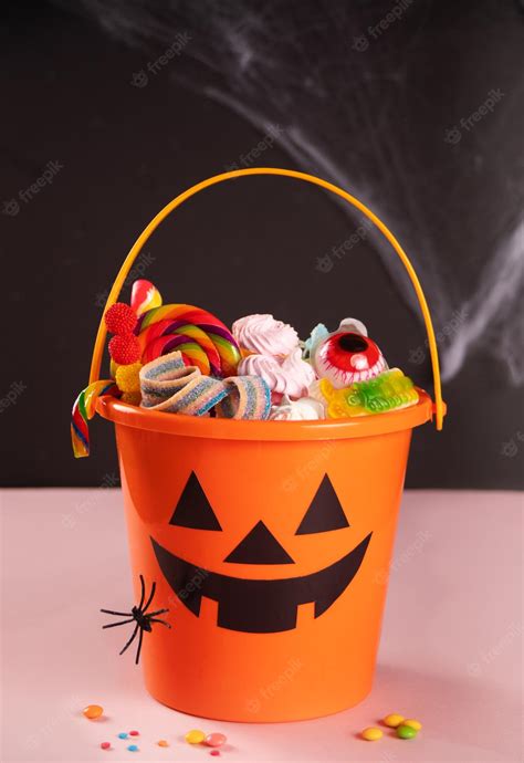 Premium Photo | Halloween jack o lantern orange bucket with candy