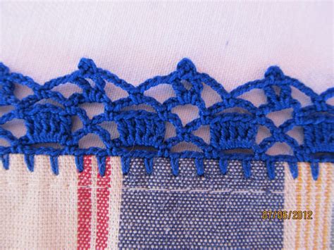 blue crocheted lace on fabric with red and white stripes