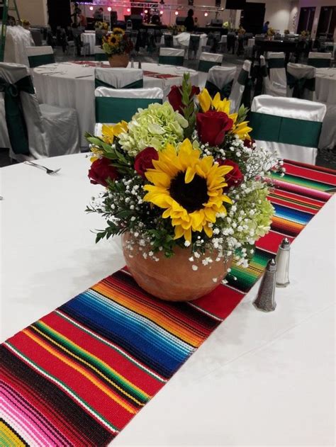 Wedding centerpiece using red roses, green hydrangea, sunflower, ruscus, boxwood and bab ...