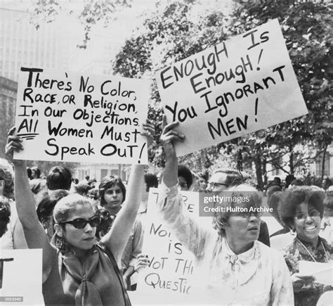 Women hold up signs demanding equal rights during a demonstration for... News Photo - Getty Images