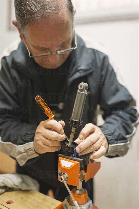 Mechanic using equipment at workshop stock photo