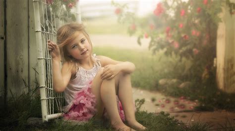 Cute Little Girl Is Sitting On Grass Leaning Back On Gate Wearing White Pink Dress HD Cute ...