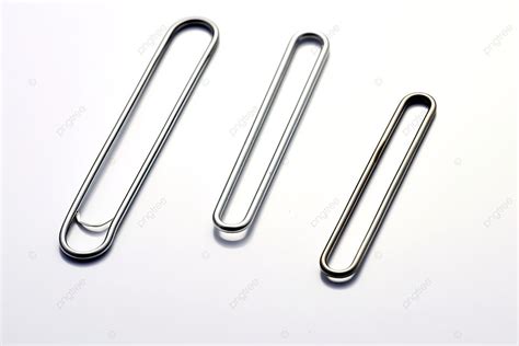 A Collection Of Three Paper Clip Shapes Laying On A White Surface ...