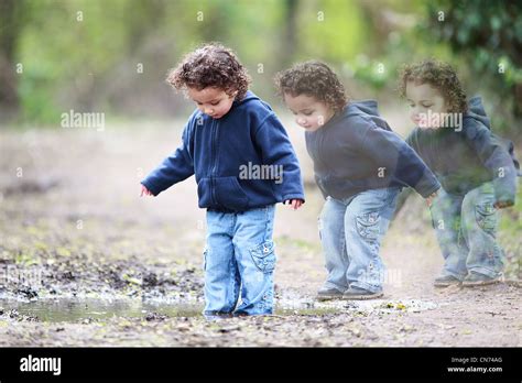 Child Jumping in Puddle Stock Photo - Alamy