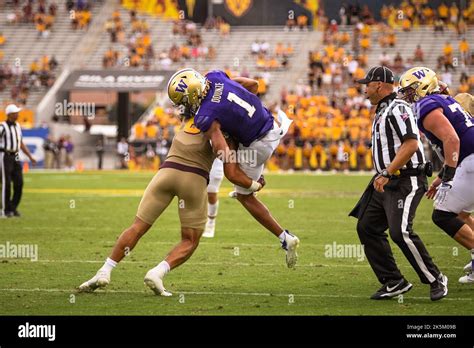 Washington Huskies wide receiver Rome Odunze (1) gets lifted and tackled to the ground in the ...