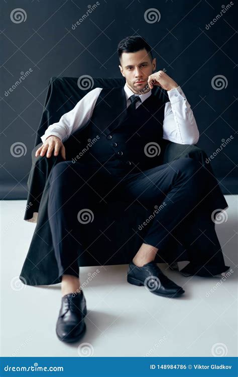 Confident Thoughtful Man in Elegant Suit Posing Sitting in Chair Stock ...