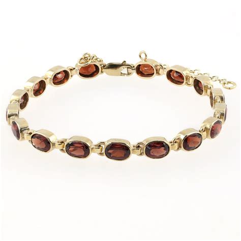 9ct yellow gold 7x5mm oval garnet bracelet - Jewellery from Mr Harold ...