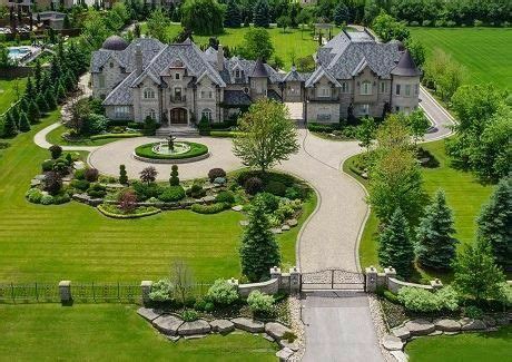 an aerial view of a large house with lots of trees and grass in the ...