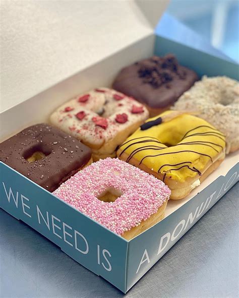 a box filled with assorted donuts sitting on top of a table