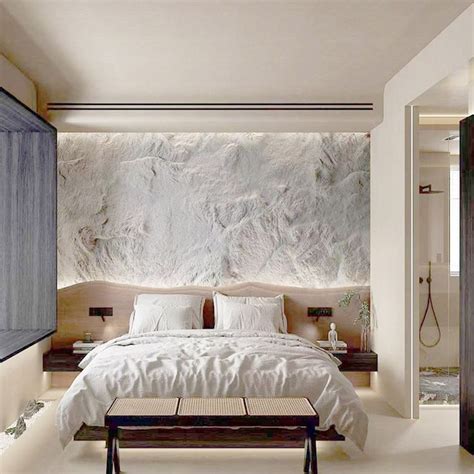 a bedroom with a large stone wall behind the bed