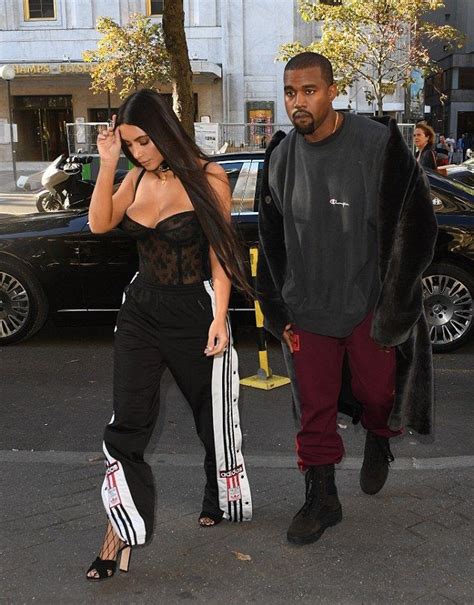 Kanye West With Kim Kardashian Wears Champion Sweatshirt, Yeezy Season Calabasas Pants And Boots ...