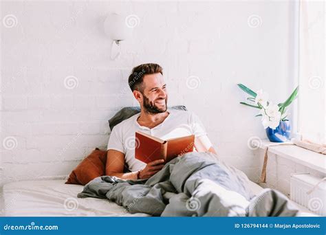 Young Man Reading a Book in the Bed Stock Photo - Image of people, attractive: 126794144