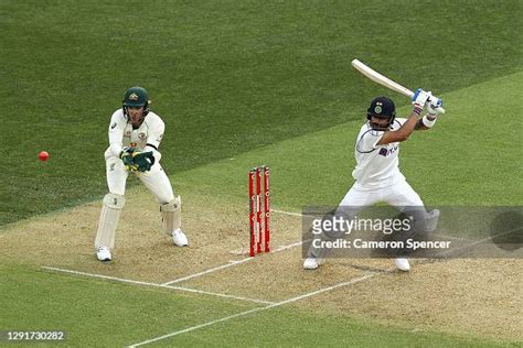 Virat Kohli of India plays a shot as Tim Paine of Australia looks on... News Photo - Getty Images