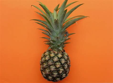 Premium Photo | Fresh ripe pineapple fruit isolate on a orange ...