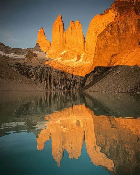 The iconic Torres of Torres del Paine National Park lit up with the first morning sun rays ...