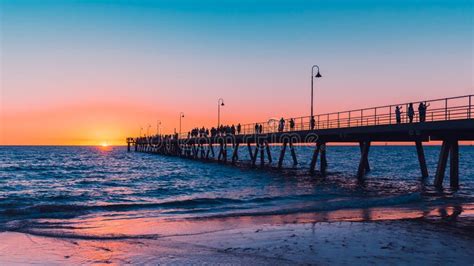 Glenelg Beach Beach Foreshore With Pier And People At Sunset Stock ...