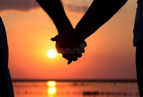 Silhouette of Couple at Sunset Holding Hands Stock Photo - Image of ...