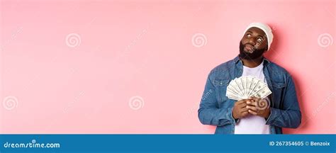 Dreamy African-american Man Thinking about Shopping, Holding Money ...