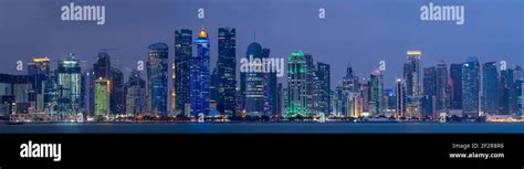 The skyline of Doha, Qatar after sunset Stock Photo - Alamy