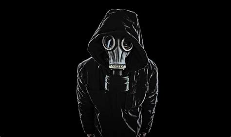 a man wearing a gas mask and black hoodie