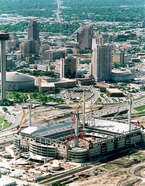 The Alamodome, under construction in this photo, opened in 1993 - The old HemisFair Arena can be ...