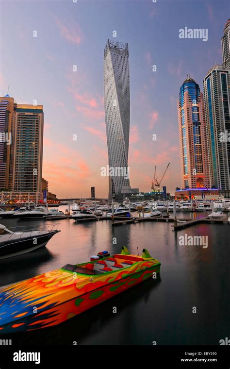 Dubai Marina skyline. Speed boat in front and twisted tower on the back ...