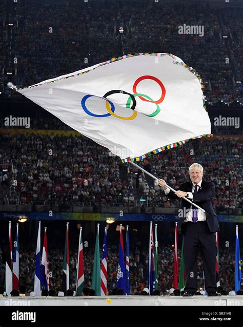 Mayor of London Boris Johnson waves the Olympic Flag during the ...