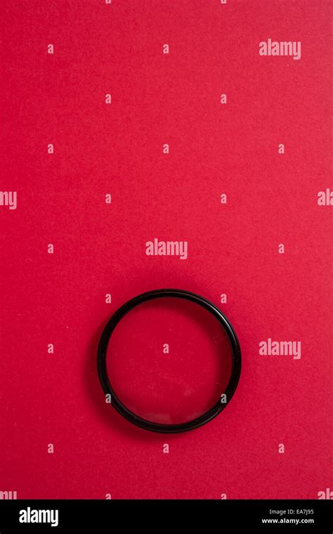 Lens filter on a red background Stock Photo - Alamy