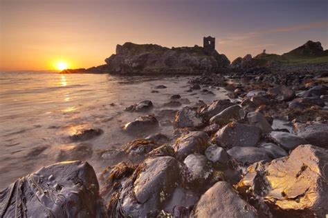 Spectacular sunrise at Kinbane Castle in Northern Ireland Stock Photo by ©sara_winter 183349322