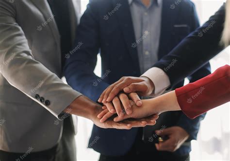 Premium Photo | Close up on hands of business people join together their hands together on unity ...