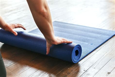 Rolling up a yoga mat | Premium Photo - rawpixel