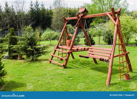 Wooden garden swing stock photo. Image of exterior, greenery - 56301046