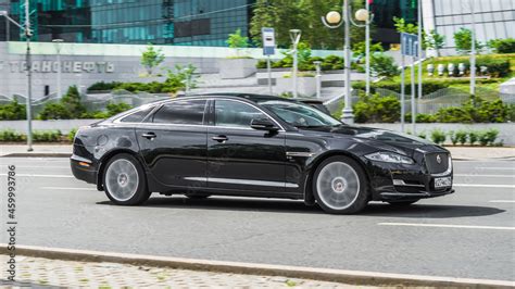 Jaguar XJ X351 black color, in motion on a city street Stock Photo ...