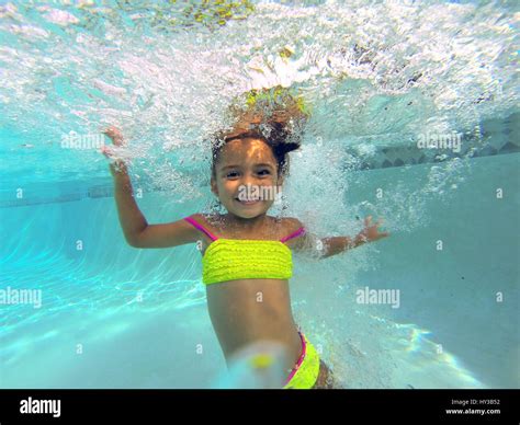 underwater in pool little girl jumps in pool smiles Stock Photo - Alamy