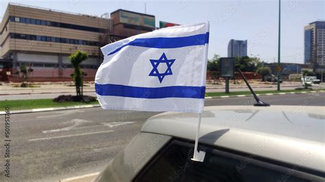 Israeli Flag waving in the wind on a car in honor of Yom Haatzmaut ...